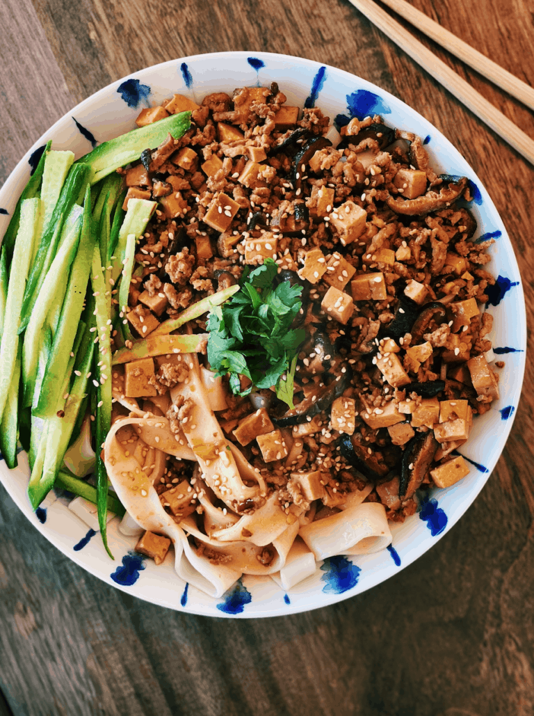 “Fried Sauce” Noodle - Zha Jiang Mian served with sliced cucumbers and garnished with cilantro