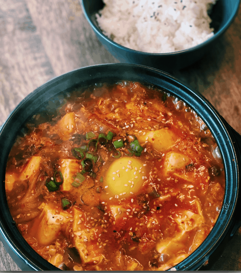 Kimchi Tofu Stew is an easy10 Minute Dinner served with a fresh egg and a bowl of rice