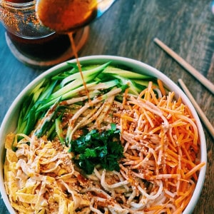 Tiffy Cooks Spicy Sesame Cold Noodles Easy Recipe with cucumber, egg, and carrots and chili oil drizzled over