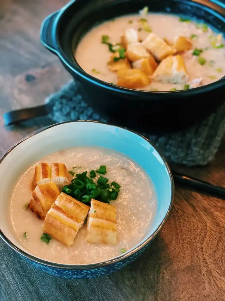 A bowl of Chicken Congee Bowl served with sliced Chinese Doughnut  