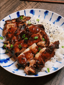 Juicy, crispy-skinned Air Fryer Soy Sauce Chicken on a plate, marinated in a blend of soy sauce, spices, and garlic, showcasing a delicious homemade meal.