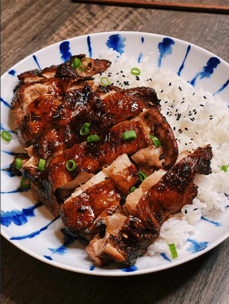 Juicy, crispy-skinned Air Fryer Soy Sauce Chicken on a plate, marinated in a blend of soy sauce, spices, and garlic, showcasing a delicious homemade meal.