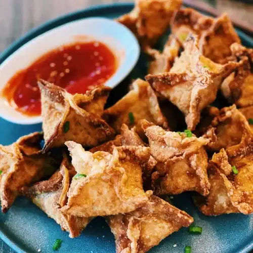 Fried Crab Rangoons served with sweet sour sauce