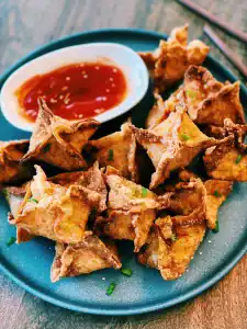 Fried Crab Rangoons served with sweet sour sauce