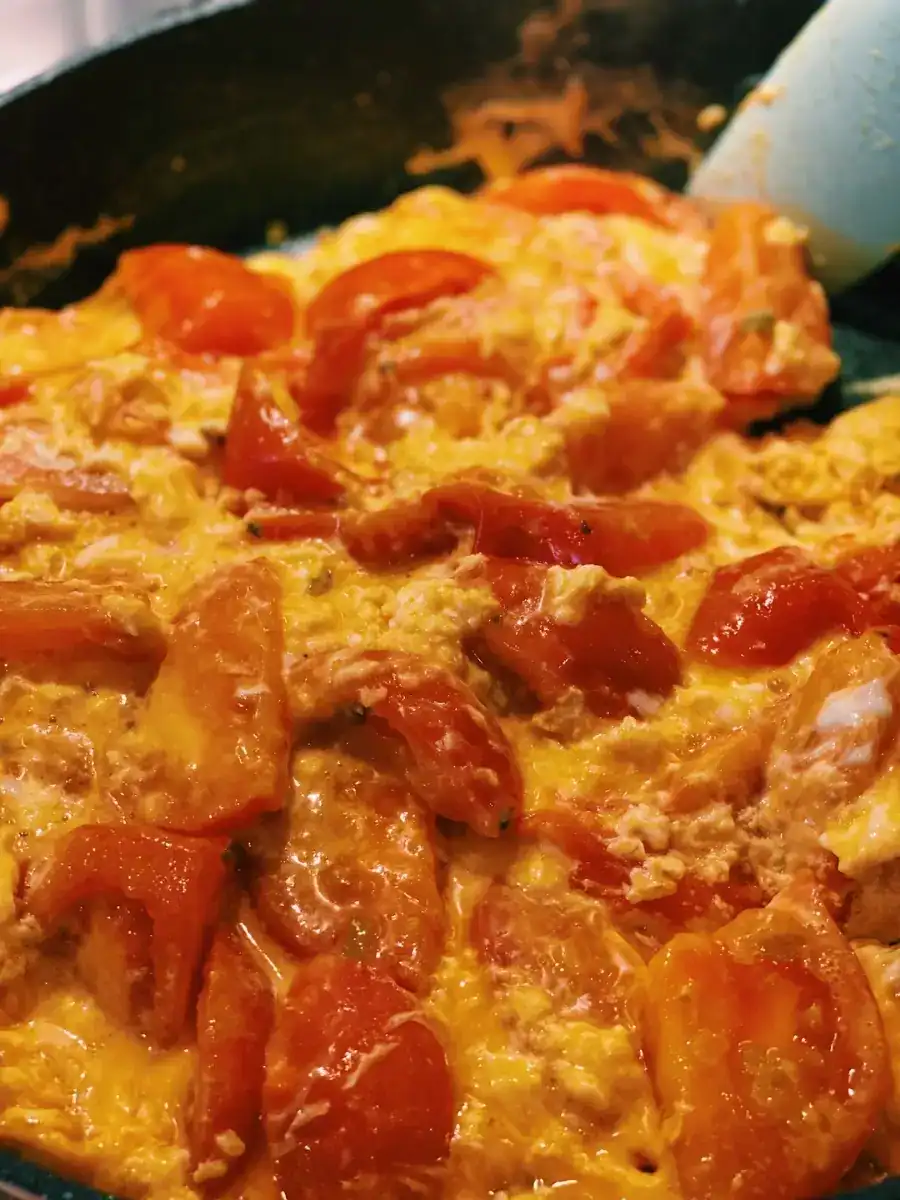 Tomato and egg sauteed together in a pan to make Tomato and Egg Stir-Fry