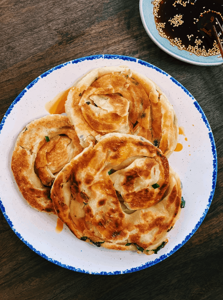 3 Homemade Taiwanese Scallion Pancakes served on a plate with sauce