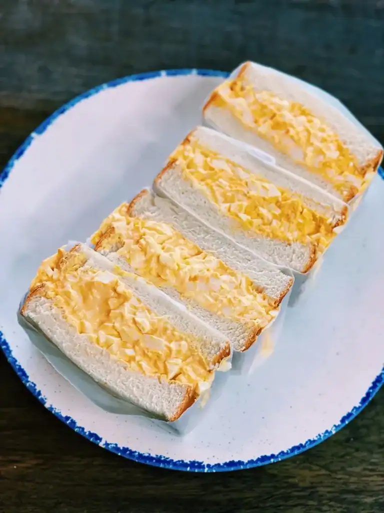 Japanese Egg Salad Sandwiches wrapped with paper for a picnic