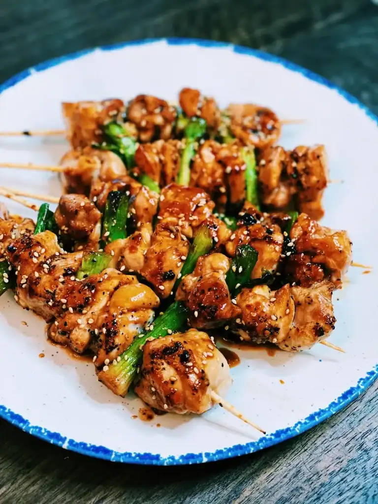 Japanese yakitori, or grilled chicken skewers served in a plate