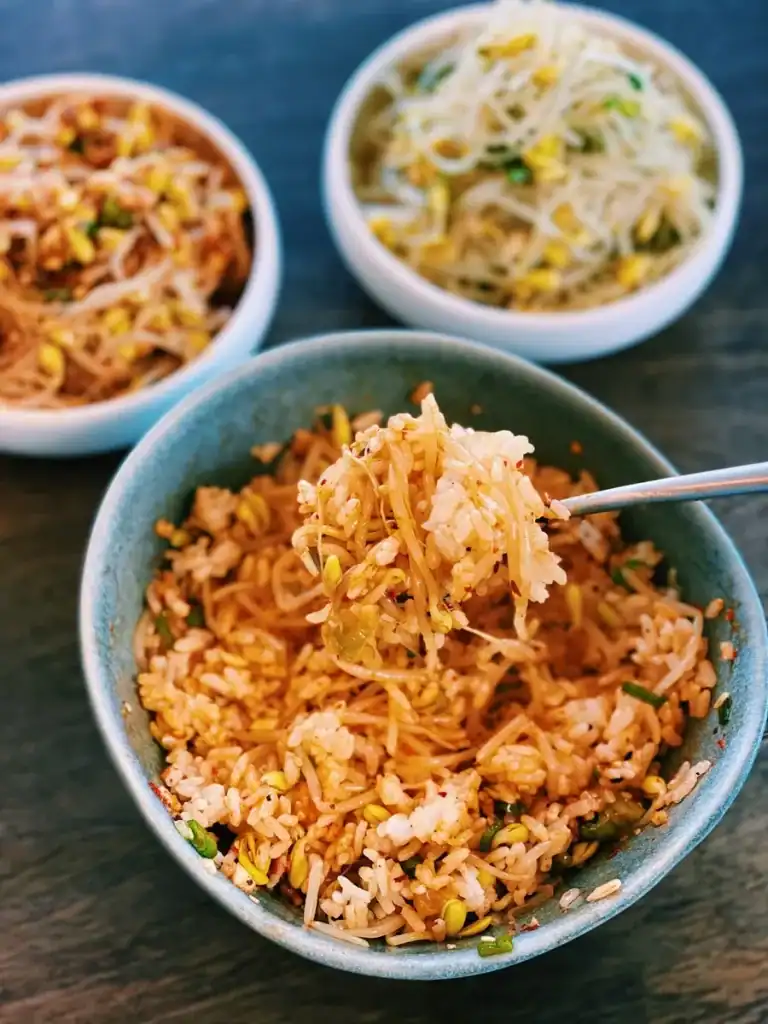Mixing Spicy and savory Korean Beansprout Side Dish with rice