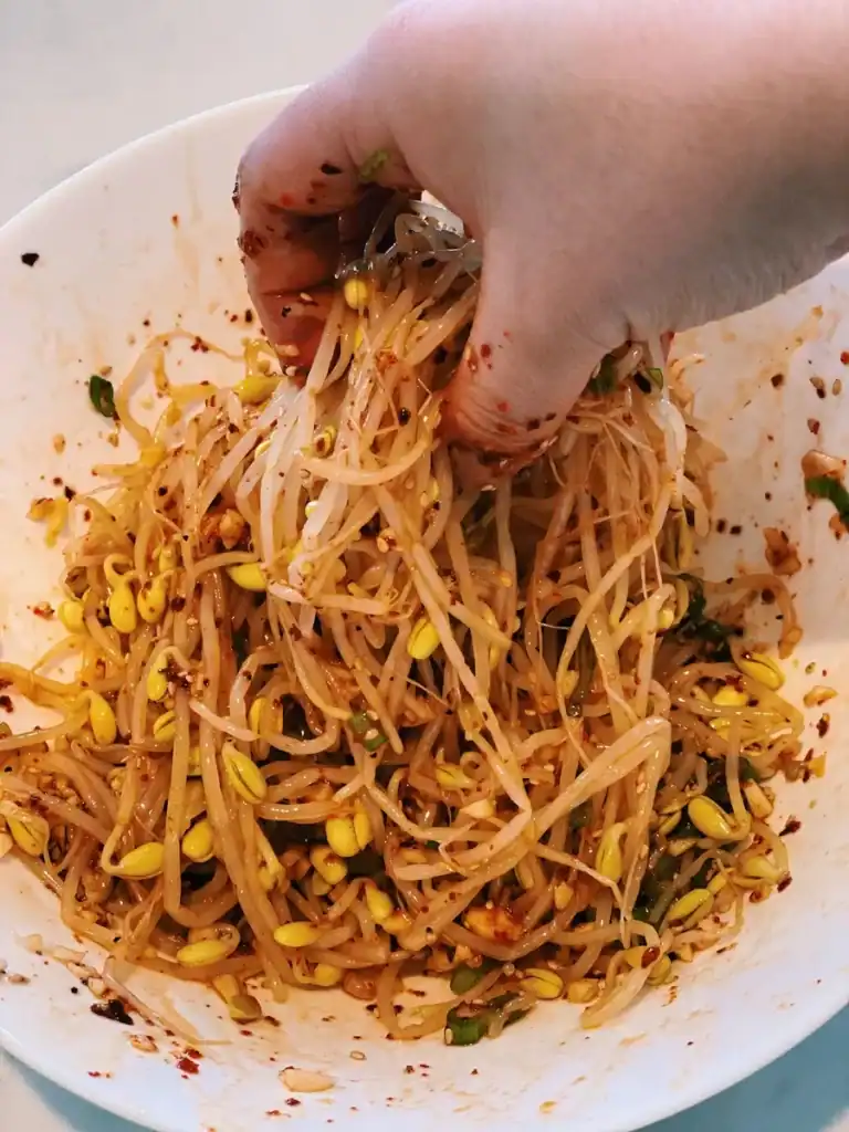 Mixing Bean Sprouts with seasoning for Korean Bean Sprout Side Dish