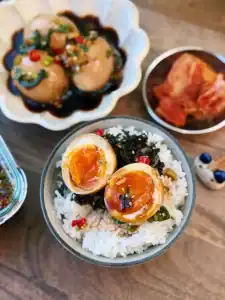 Korean Soy Marinated Eggs, or Mayak Gyeran, sliced and served on top of hot rice.