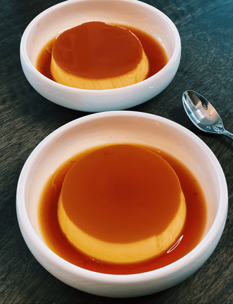 An image showcasing a smooth and silky Japanese Caramel Custard Pudding, known as Purin, served in a glass dish, a favorite Asian dessert for the holidays.