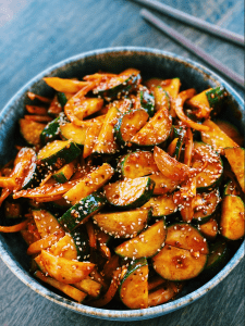 Image of a Spicy Korean Cucumber Salad, featuring crunchy cucumbers in a savory, spicy sauce, a refreshing vegetarian Asian dish.
