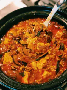 A scoop of spicy tofu with ground pork, or mapo tofu