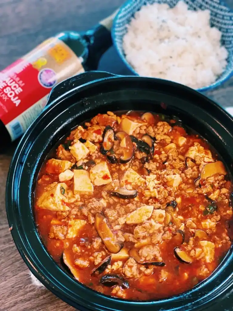 Mapo Tofu in a pot with white rice nearby