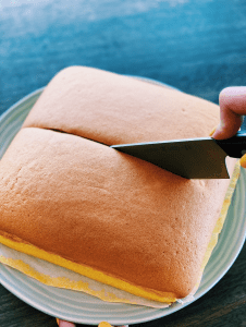 Photo of a moist and fluffy Taiwanese Honey Castella Sponge Cake, sliced to showcase its soft texture, a favored Asian dessert for Christmas celebrations.
