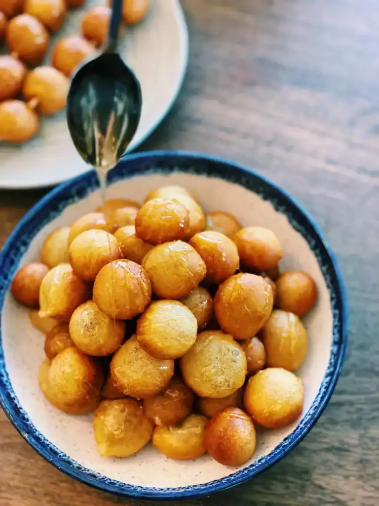 Drizzling Honey on top of Sweet Potato Balls 