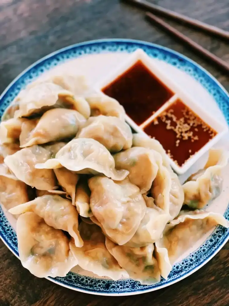 Boiled vegetarian dumplings served with 2 dipping sauces