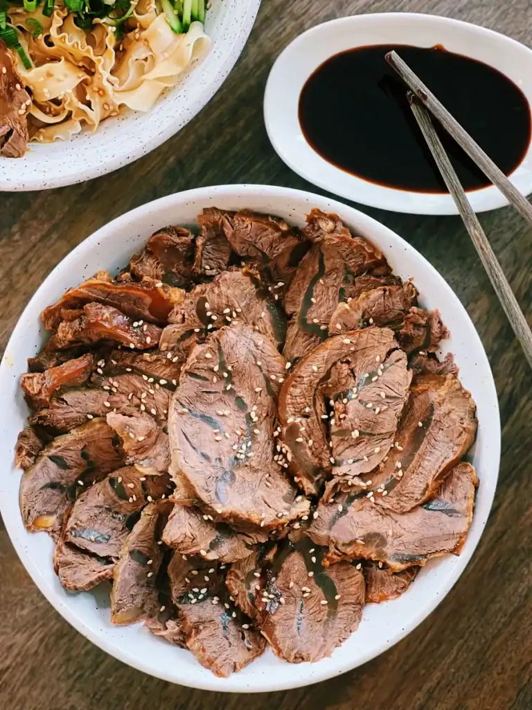 Sliced Taiwanese Beef Shank on a plate served with dipping sauce