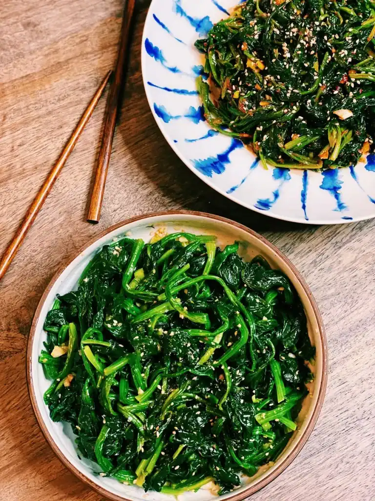 Two dishes of Korean Spinach, spicy and savory