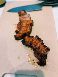 Slicing Air Fryer Honey Glazed BBQ Pork to show desired doneness