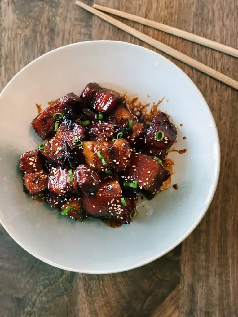 Top view of a bowl of sticky pork belly