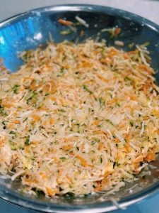 Mixing gluten free batter of leftover vegetables, corn starch, and egg for mini vegetable pancakes