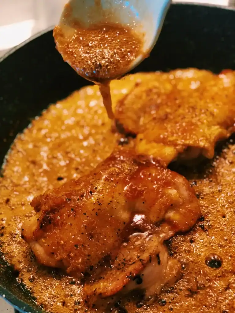 Drizzling Honey Ginger Sauce over the chicken thigh for juicy Honey Ginger Chicken