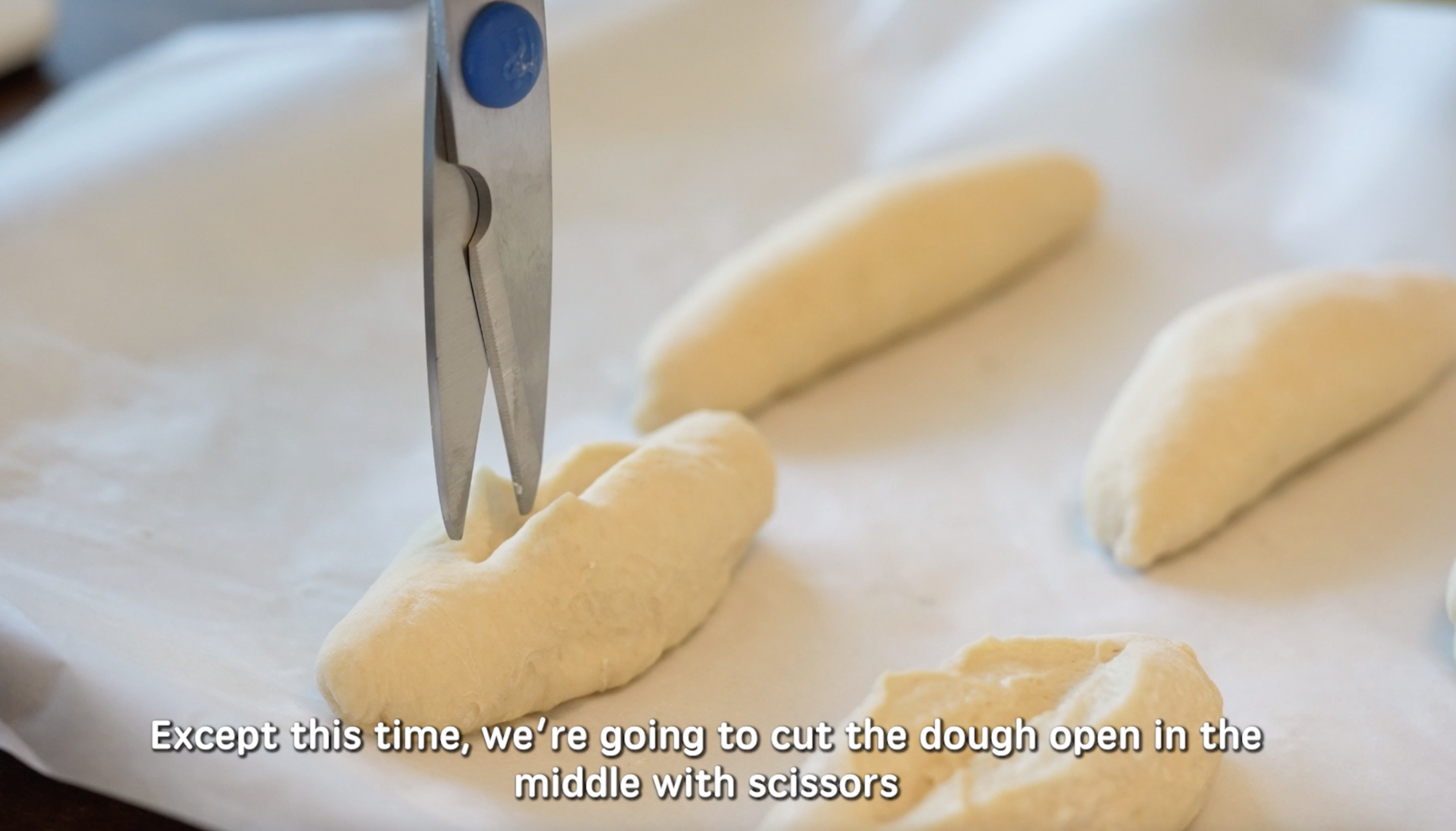 cutting slits in Asian Milk Bread Dough for Cheesy Tuna Buns.