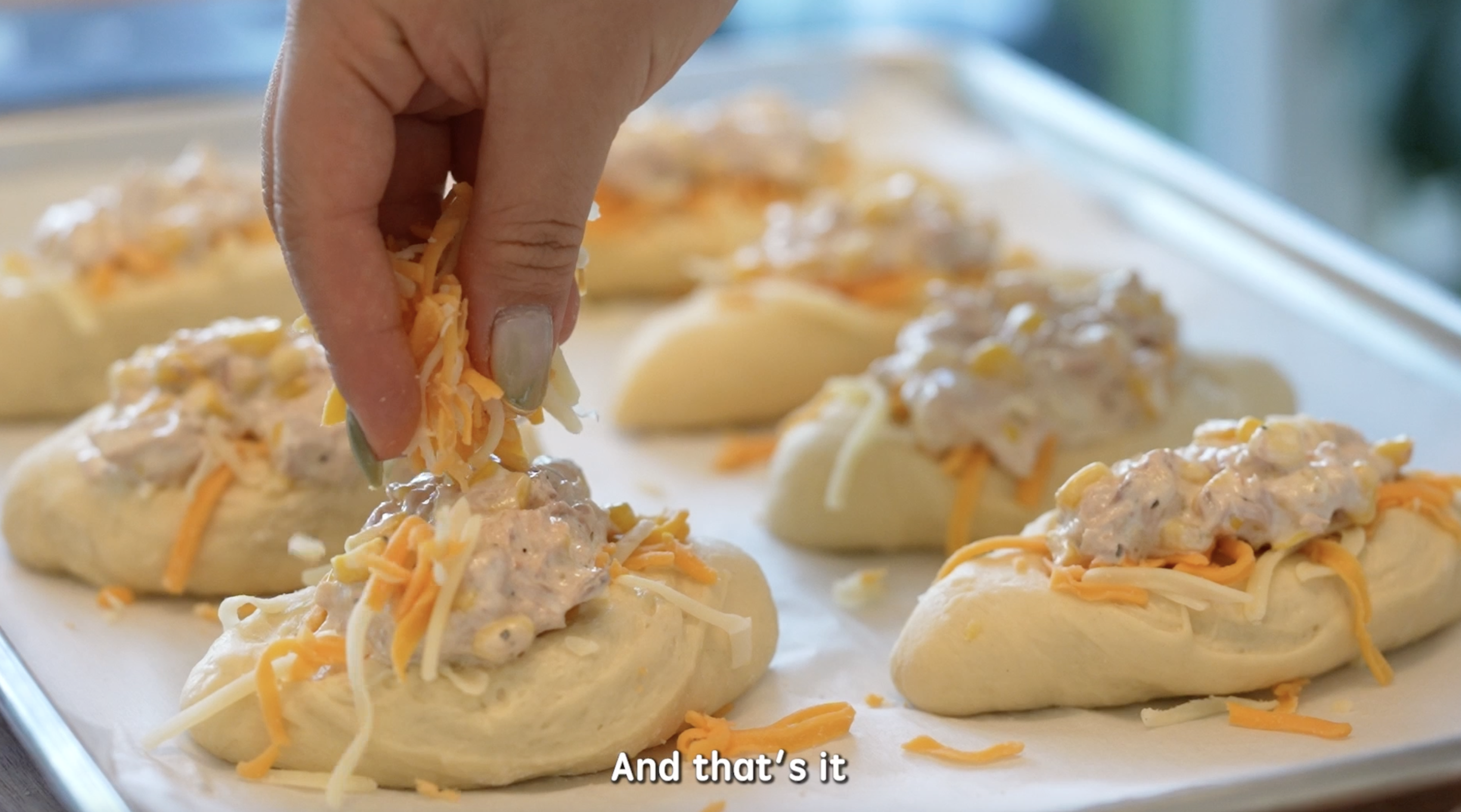 Adding Cheese and tuna on top of Asian Milk Bread Dough for Cheesy Tuna Buns.
