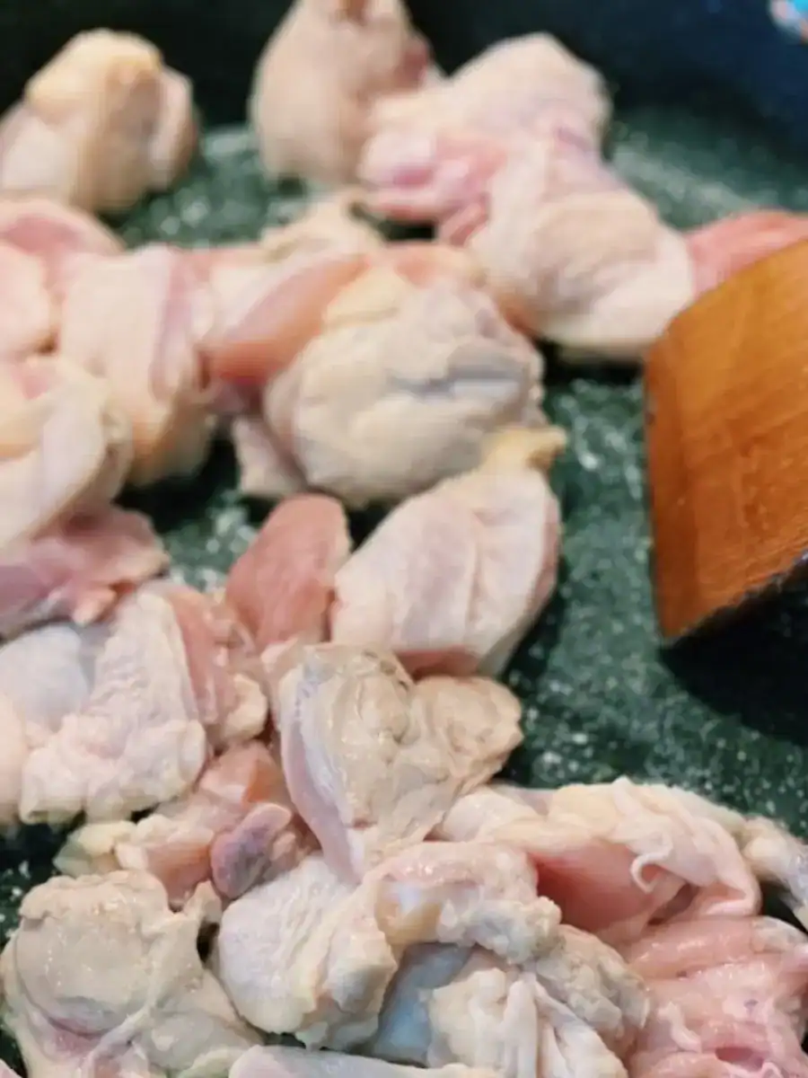 Sauteing chicken in the pan for Taiwanese 3 Cup Chicken Noodle Stir Fry