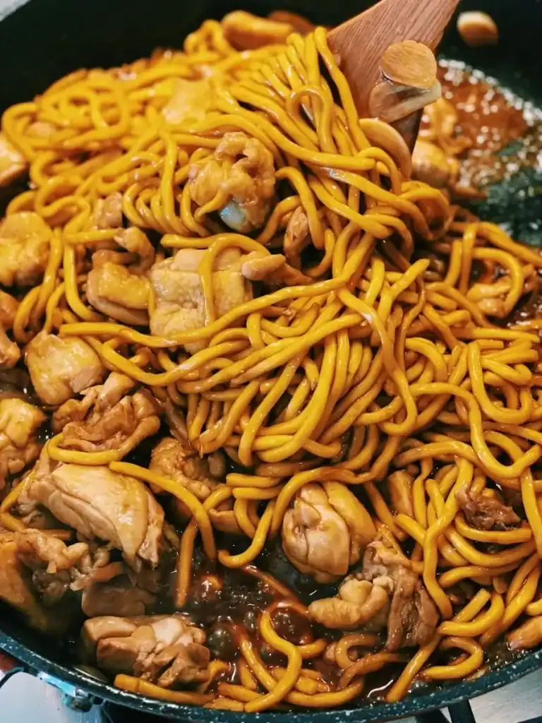 Sauteing Taiwanese 3 Cup Chicken Noodle Stir Fry Until it is mixed well together