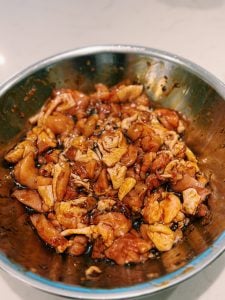 Marinating chicken thigh bites for soy glazed chicken rice bowl