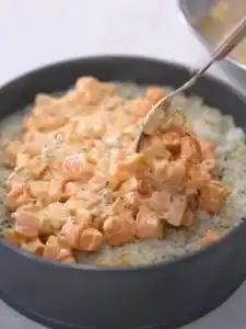 Add a layer of spicy salmon on top of the layer of rice for Mayo Crab Spicy Salmon Sushi Cake