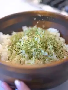 Mixing furikkake and white rice for Mayo Crab Spicy Salmon Sushi Cake