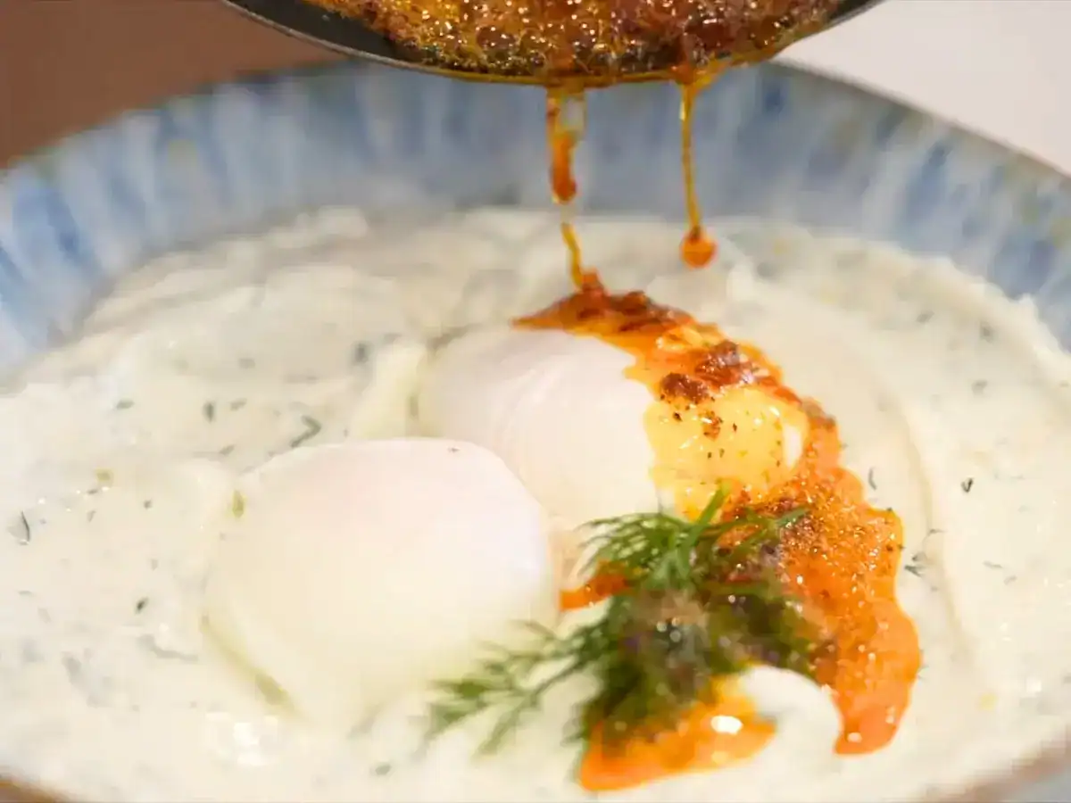 Hot Chili Oil Butter drizzled on top of herbed yogurt and poached eggs for the perfect turkish eggs with asian chili ol