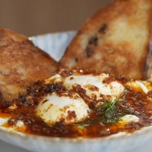 Turkish Eggs with Chili Oil Served with Toasted Olive Bread