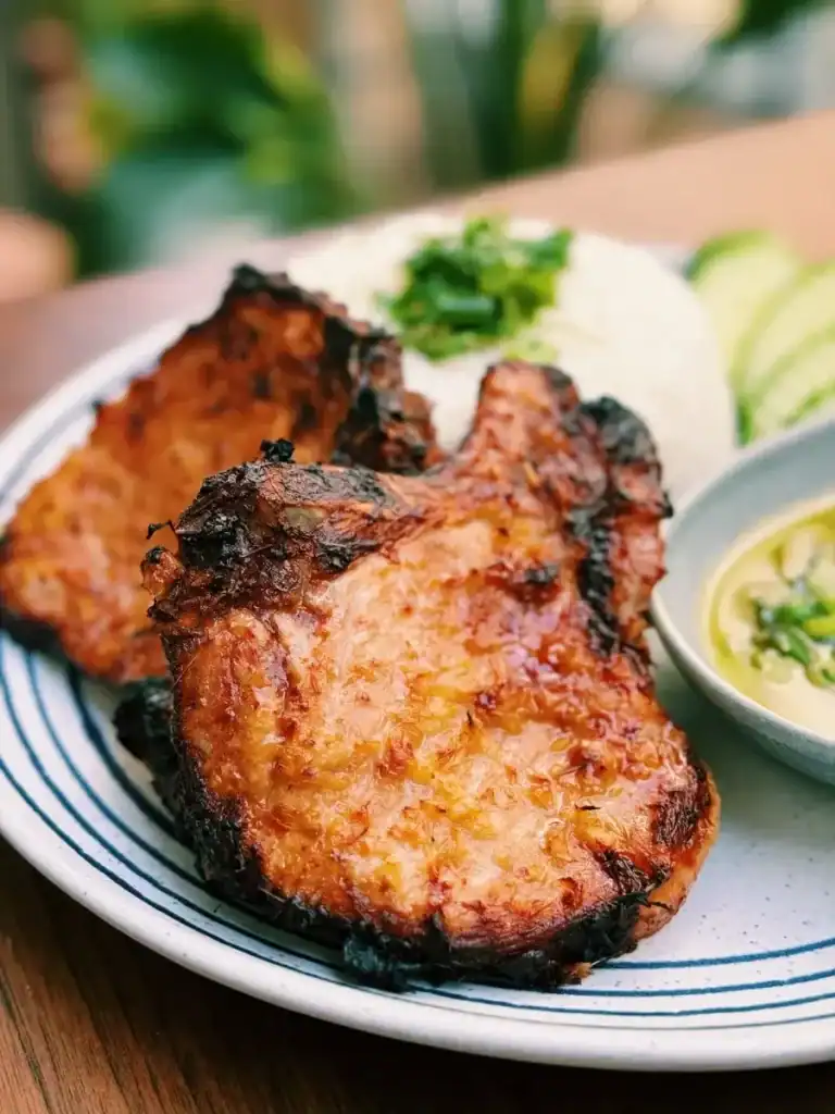 Golden Air Fried Lemongrass Porkchops Served with Scallion Sauce, Rice, and Sliced Cucumbers