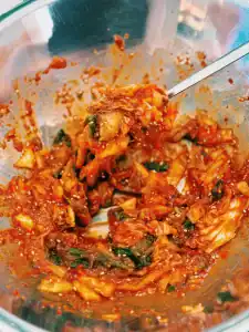 chopping kimchi for sauce mix to make Bibim Guksu or Spicy Korean Cold Noodles great for Summer!