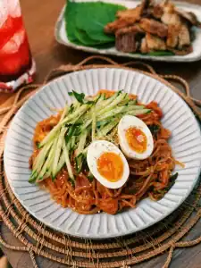 Korean Spicy Cold Noodles served with cucumbers and soft boiled eggs