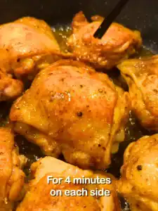 In a pan, drizzle in oil and turn the heat to medium-high. Place the chicken skin side facing down first, and pan-fry for 4 minutes on each side. Remove and set aside on a plate for the chicken and rice later.
