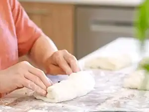 Tiffy's Mom show up how to fold the dough for the no knead bread to keep all the fillings inside the bread while baking