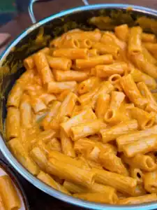 Adding sauce for Dairy-Free Butternut Squash Pasta into the pan