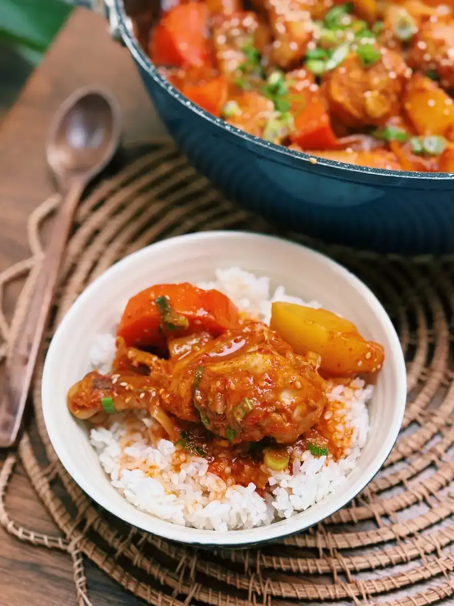 Spicy Savory Dakdoritang scooped into a bowl of rice