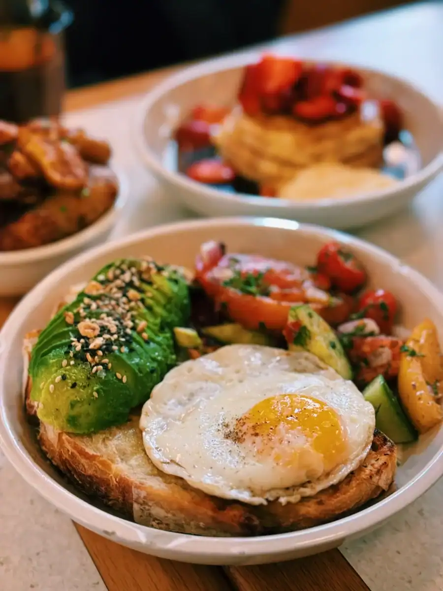 Endless Summer breakfast bowl ($22.99) with avocado, house-made sourdough, fried eggs, house tzatziki, and a ton of fresh, in-season veggies at Dandy in Old Montreal