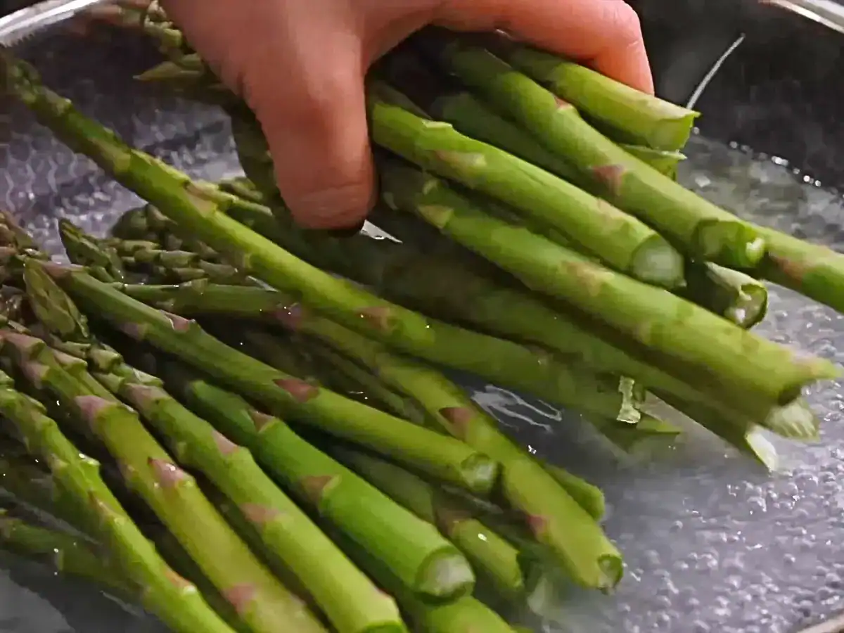 Adding fresh asparagus into boiling water for 4 Ingredient Everyday Garlic Butter Asparagus