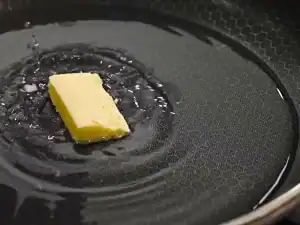 Adding a pat of butter into boiling water to start cooking 4 Ingredient Everyday Garlic Butter Asparagus