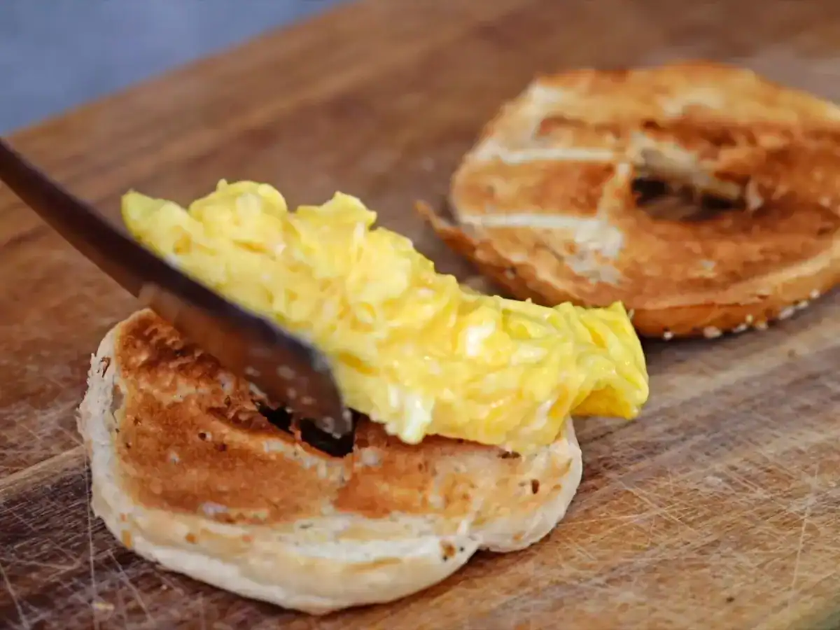 Putting scrambled eggs on top of the toasted Japanese Bagels you made