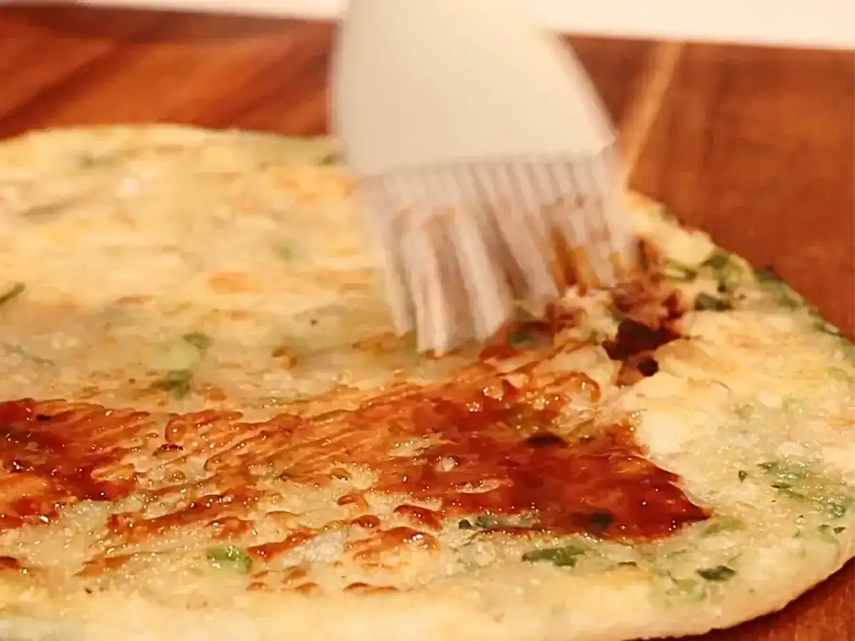 Sweet bean sauce covering Taiwanese scallion pancake to make Taiwanese scallion pancake beef roll
