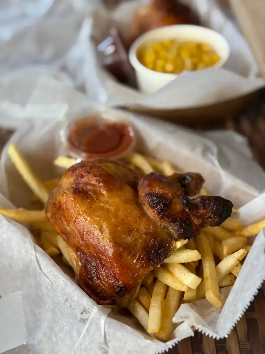 Maui Mike’s Fire-Roasted Chicken served with fresh fries on parchment paper in a basket in Honolulu, Oahu, Hawaii